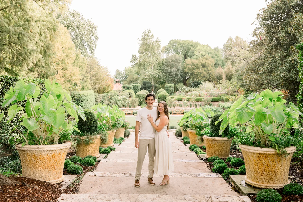Matt and Brooke together on a garden path, surrounded by greenery.